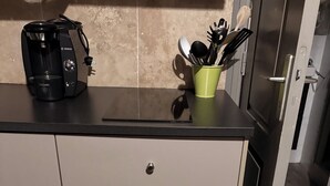 A kitchen with a coffee maker, a utensil holder, and a cabinet. - Gloria's house ...   (Saint-Rémy-De-Provence)