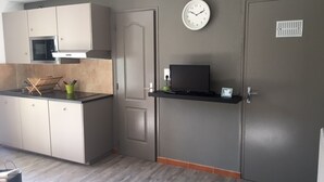 A modern kitchen with a microwave, stove, and a clock on the wall. - Gloria's house ...   (Saint-Rémy-De-Provence)