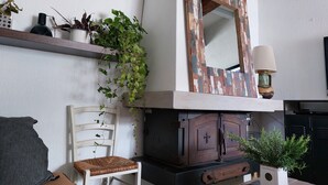 A living room with a fireplace, a mirror, and various plants. - THE FLEET IN RE classified ** (La Flotte)