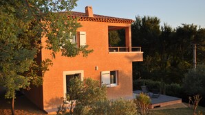A two-story house with a balcony, surrounded by trees and a small patio area. - With view on the lake of Ste Croix, contemporary villa for 8 people  (Bauduen)