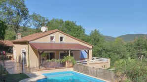 A house with a swimming pool, surrounded by greenery and hills. - Villa with private pool in a quiet location with mountain views 5 min from Ceret (reynes)