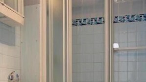 Une salle de bain avec des toilettes, un lavabo et une douche.