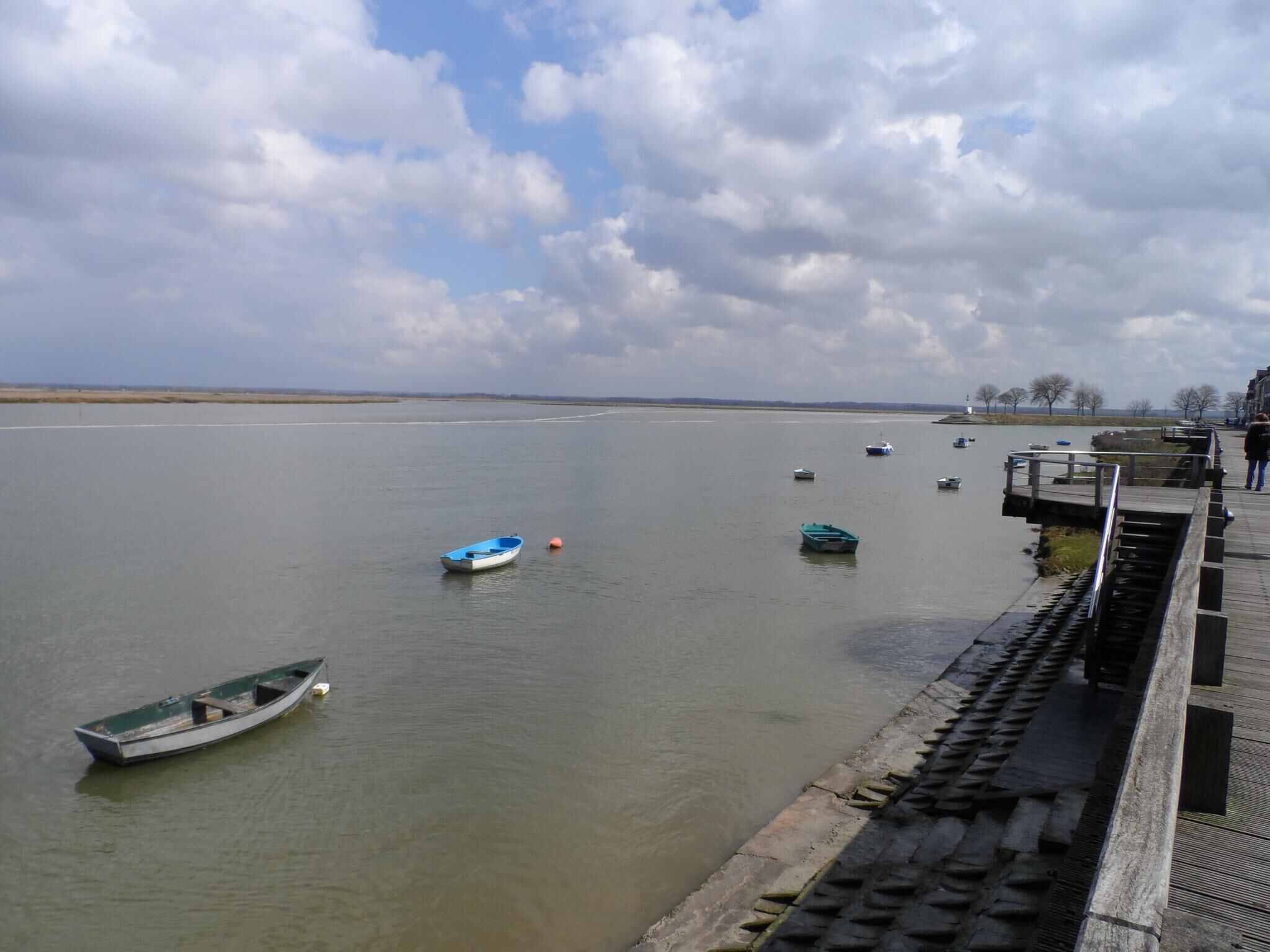 A river with boats and a dock.