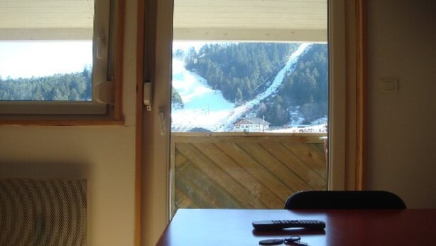 A room with a view of a snowy landscape through a window. - STUDIO No. 15, on the station (Gérardmer)