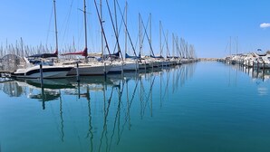 A marina with multiple boats docked in calm waters. - Charming sea view villa quiet close to the beaches (Le Lavandou)