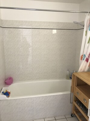 Bathtub, hair dryer, soap, shampoo