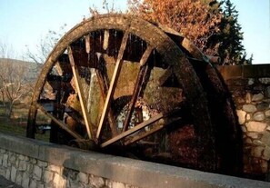 Explore the historic water wheel, a relic of a bygone era, set amidst a serene rural landscape.