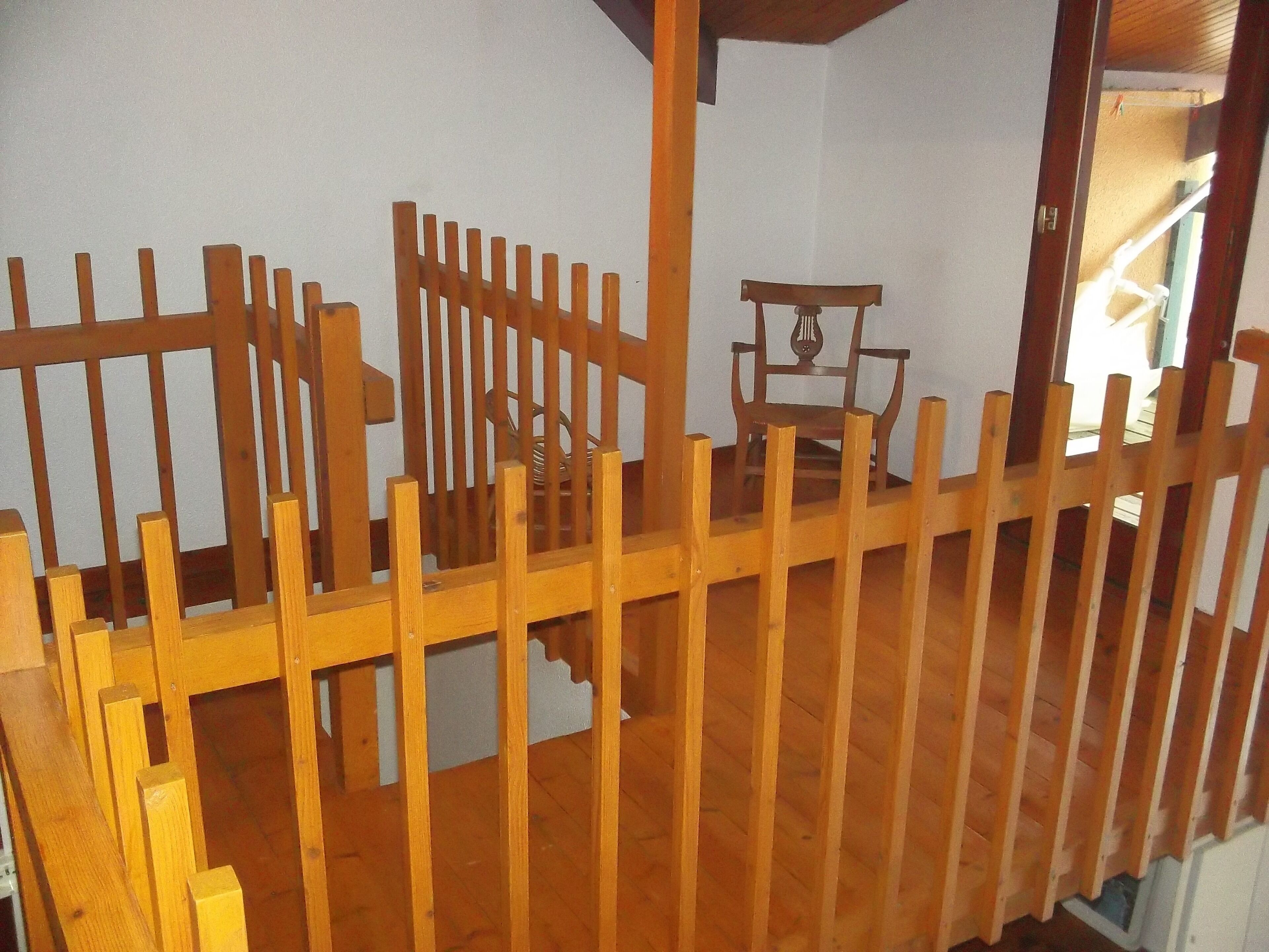 A room with a wooden partition and a small table with a decorative item.