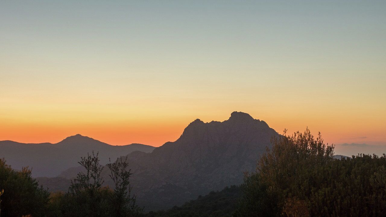 A mountain range silhouette during sunset.