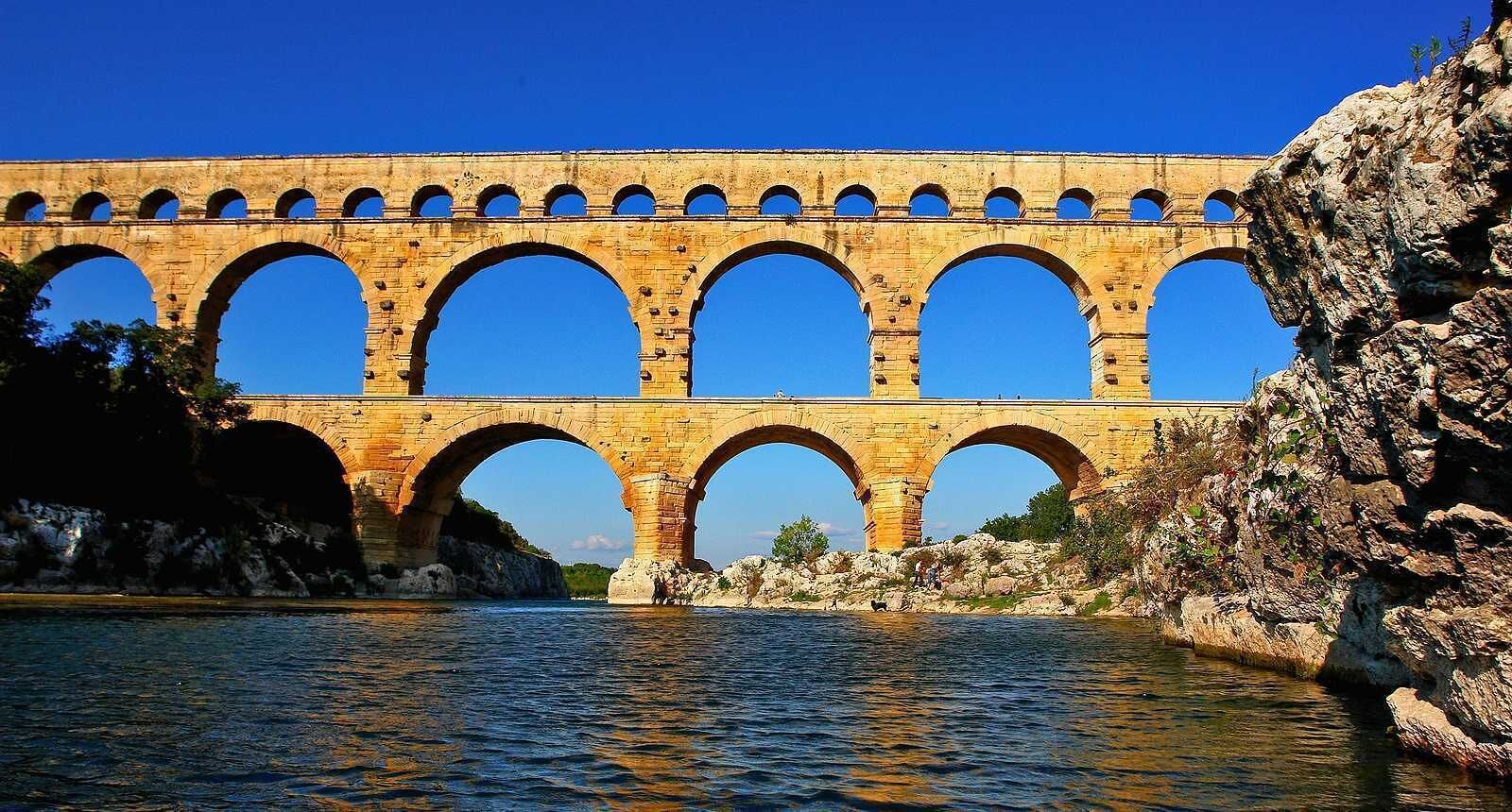 A stone bridge with multiple arches over a river.