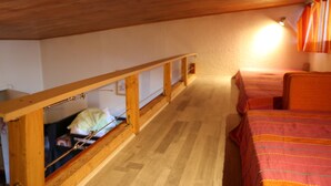 A small, cozy attic bedroom with a wooden ceiling and a single bed. - Studio for rent located in heart of French Alpes for up to 5 people (Orcières)