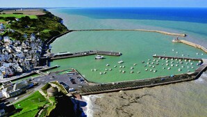 An aerial view of a coastal town with a marina, a lighthouse, and a historic building. - Quiet House 300m Landing Beach 6 Pers (Asnelles)