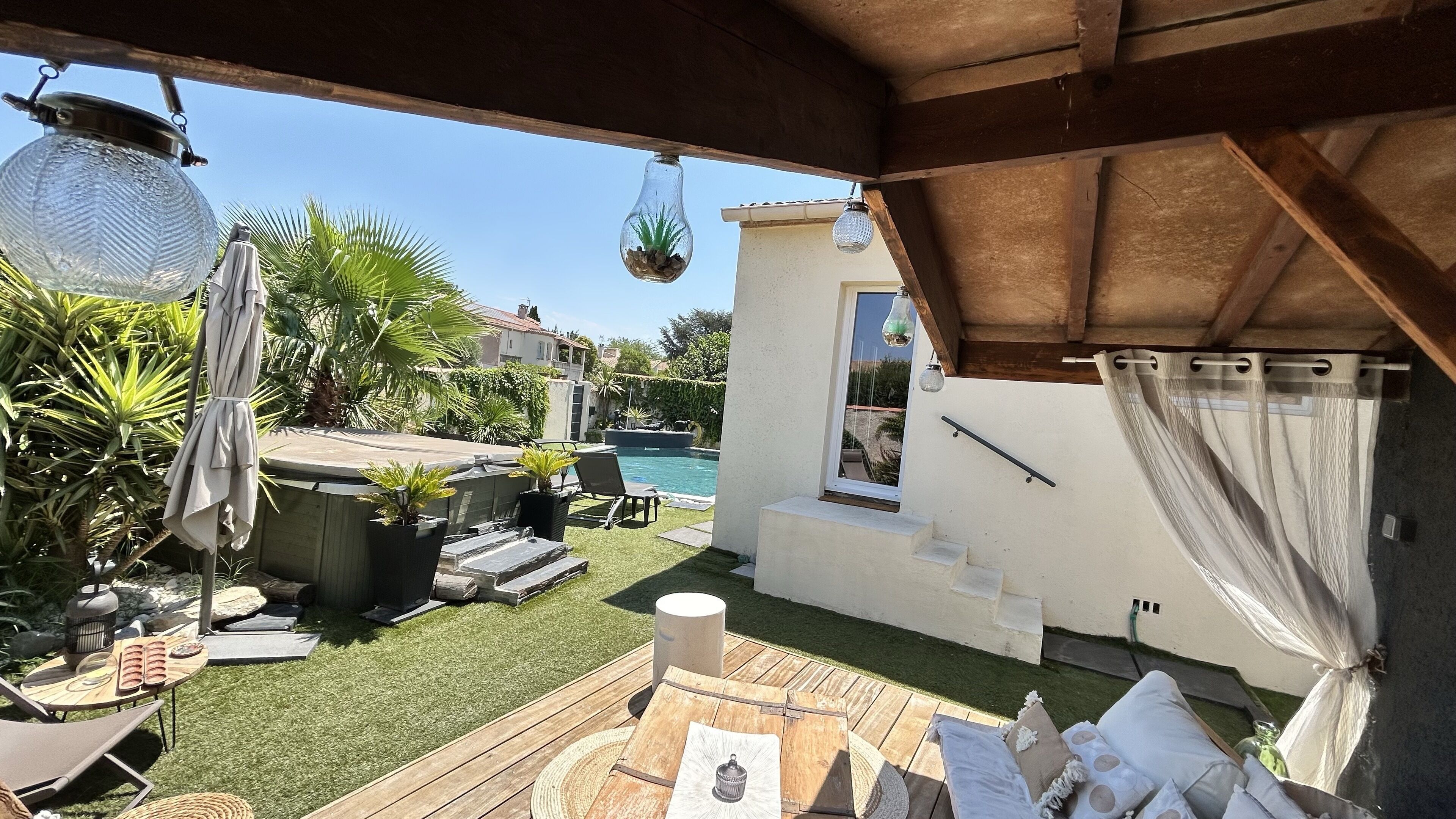 A patio area with a pool, outdoor furniture, and a pergola.