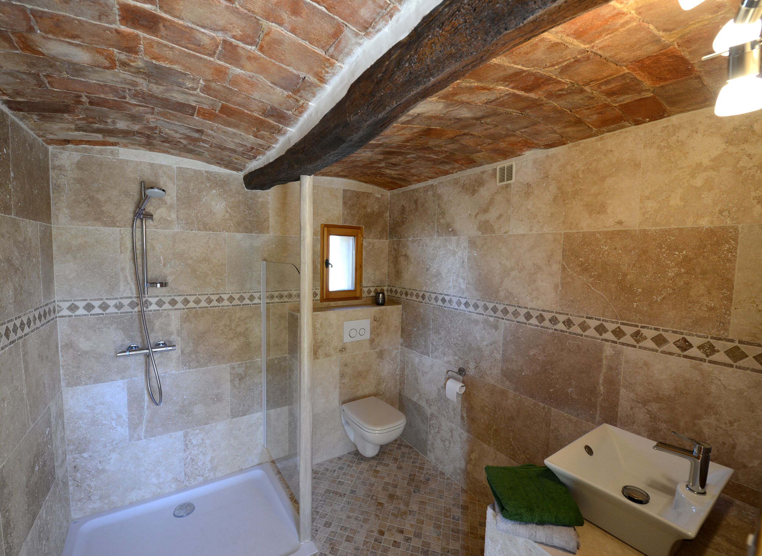 A bathroom with a bathtub, a shower, a toilet, and a sink.