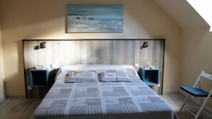 A bedroom with a large bed, two bedside tables, a chair, and a painting on the wall. - House on the outskirts of Saint Malo and on the banks of the Rance, 2 bedrooms, 2 bathrooms  (Saint-Jouan-Des-Guérets)