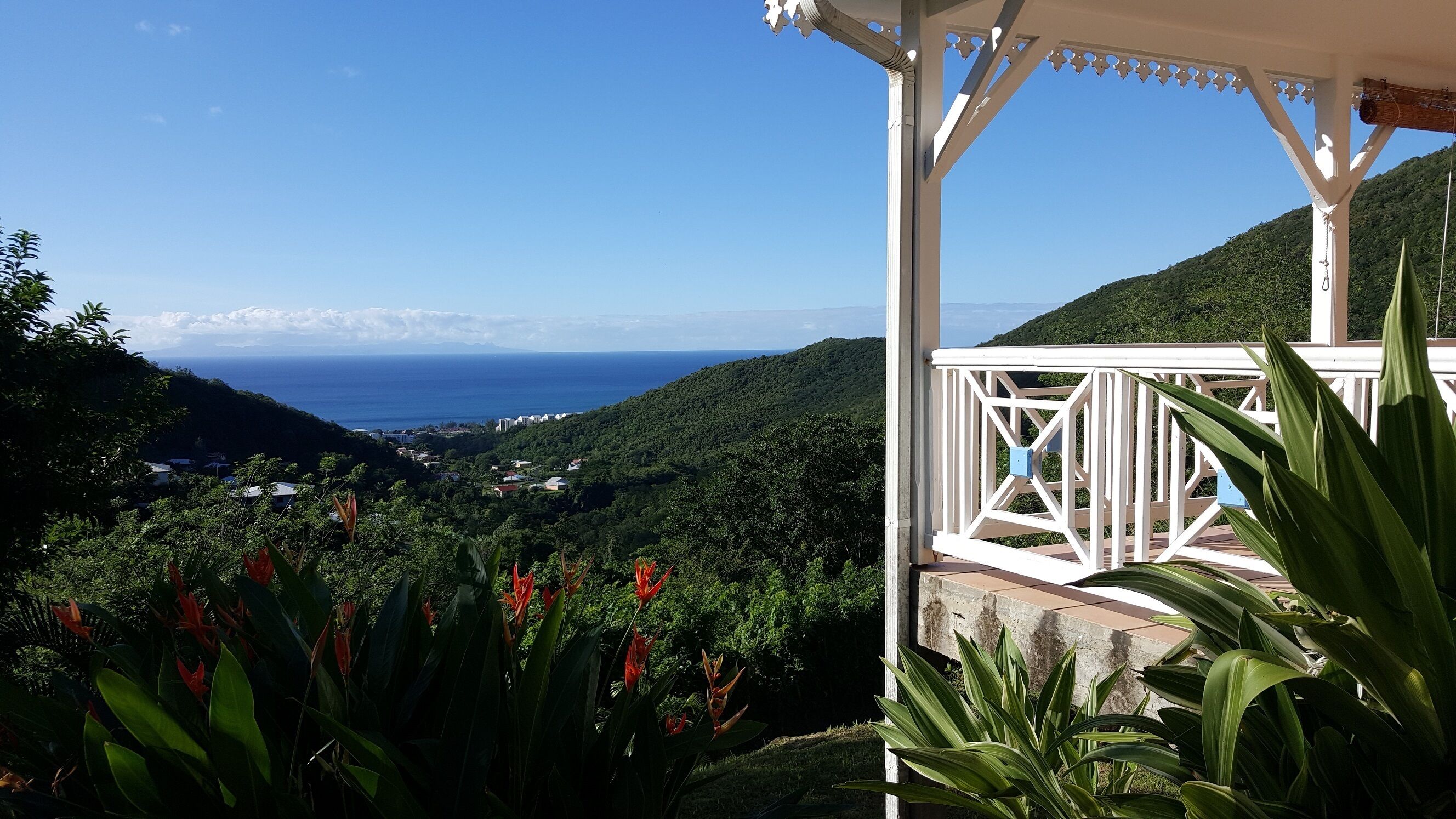 A gazebo with a view of the ocean and lush greenery.