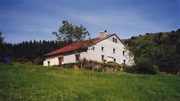 A white house with a red roof, surrounded by green grass and trees. - Have a breath in our mountains. (La Bresse)