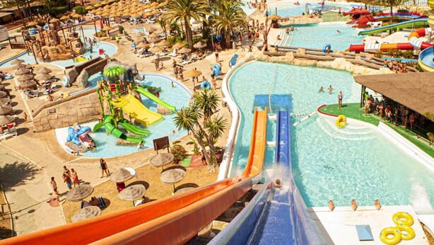 A water park with multiple slides and pools, surrounded by sun loungers and umbrellas. - Superb villa Sea views Heatable pool 5 min walk to beach & all amenities (La Cala de Mijas)