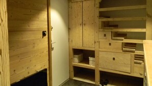 A wooden cabinet with multiple shelves and drawers, likely used for storage.