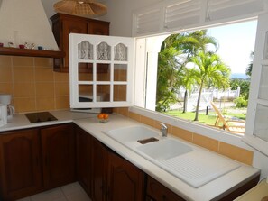 Fridge, microwave, stovetop, coffee/tea maker - Studio South East, large terrace facing the sea in tropical garden. (capesterre belle eau)