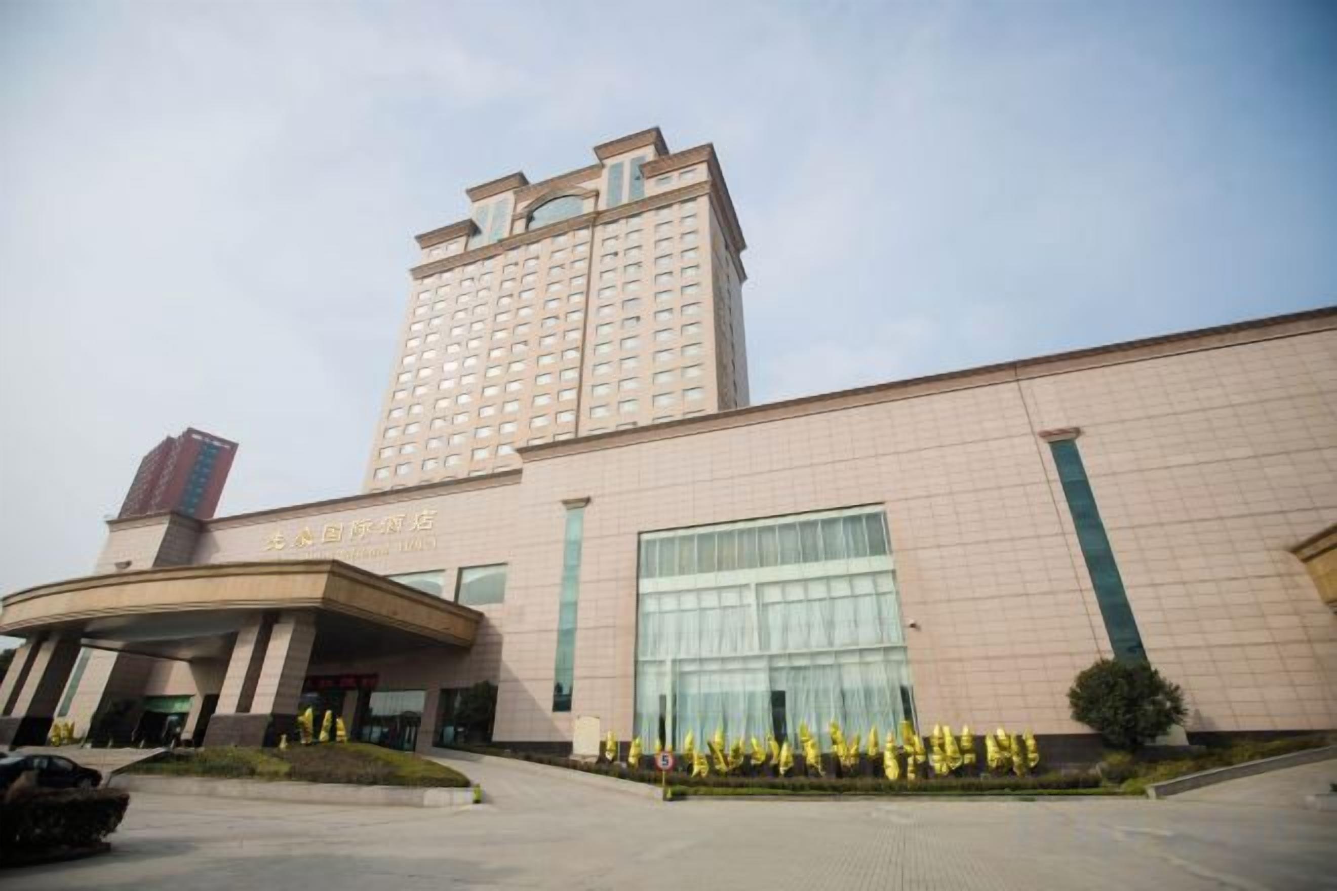 A multi-story hotel with a prominent entrance and a large glass facade.