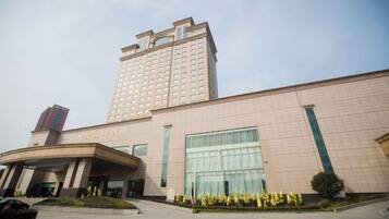 A multi-story hotel with a prominent entrance and a large glass facade.