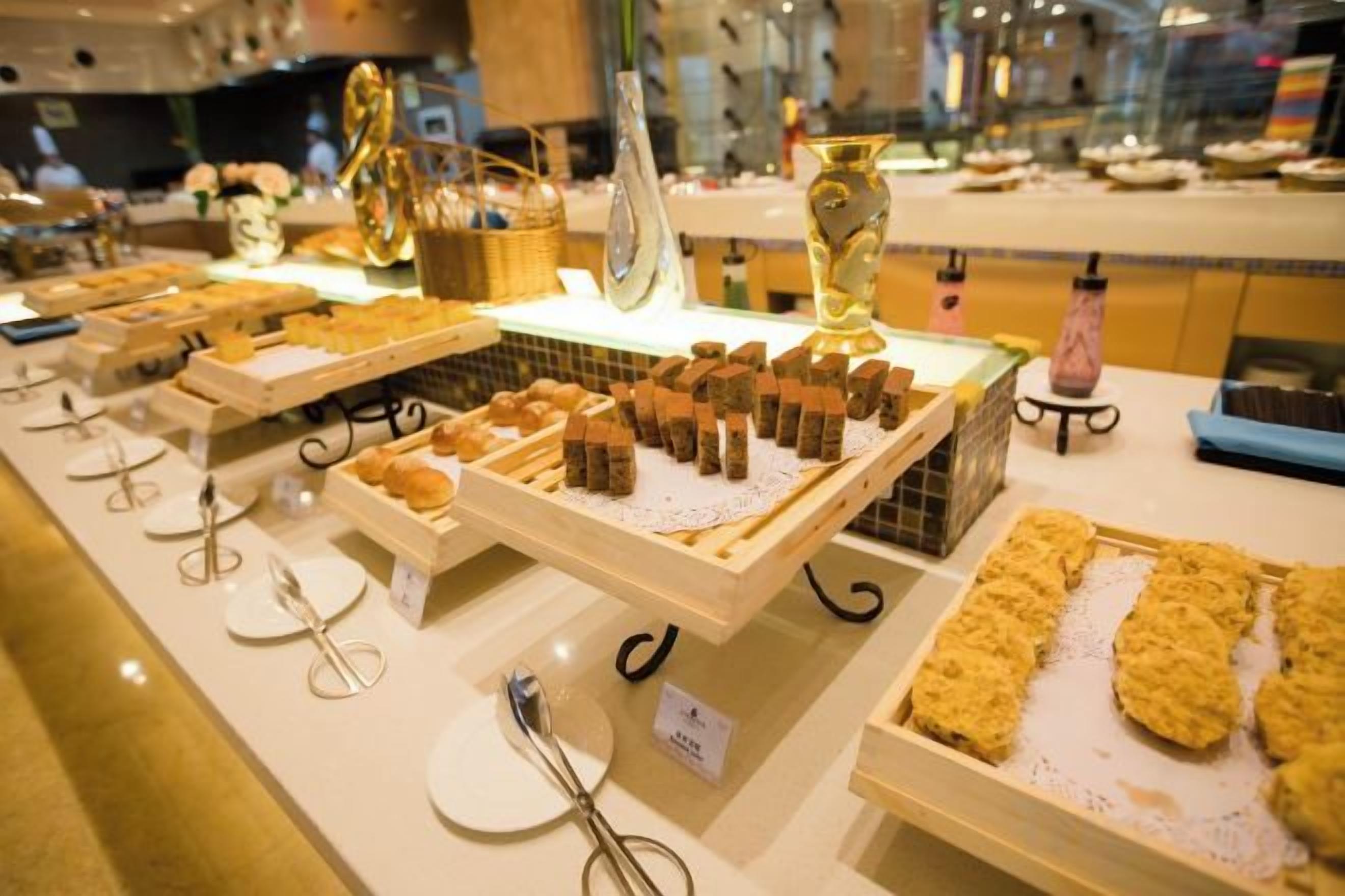 A buffet with various food items and utensils.