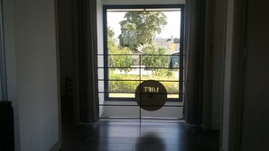 A door with a metal grid and a sign that reads "TIO". - Detached family home in the bay of mont saint michel in Cherrueix (Cherrueix)