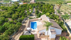 Enjoy a refreshing swim in the pool or relax on the patio surrounded by a beautiful garden.