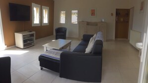 A living room with a sofa, a coffee table, a TV, and a cabinet. -  Between Ventoux and Luberon *** (Aurel)