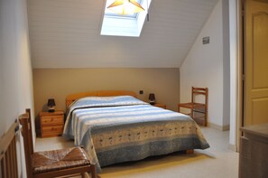 Cozy retreat with a double bed, bedside tables, and a comfortable chair.