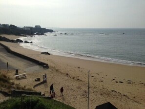 Walk along the beach on a paved path, taking in the serene coastal views.