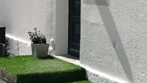 A white building with a black door, a small window, and a wall-mounted light fixture. - Appt House 72M² 2/4 persons 50m SEA BEACH (Châtelaillon-Plage)