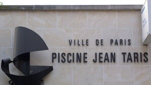 Un panneau indiquant un lieu, avec les inscriptions « VILLE DE PARIS » et « PISCINE JEAN TARIS ».