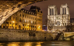 A historic building with a large arched bridge in the foreground.