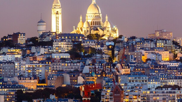 Une vue urbaine avec un bâtiment à coupole imposant et une tour en arrière-plan.