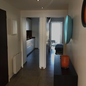 A hallway leading to a kitchen and a bedroom. - Appart. 75 m2 2 bedrooms location facing the sea and in the heart of Palavas (Palavas-Les-Flots)