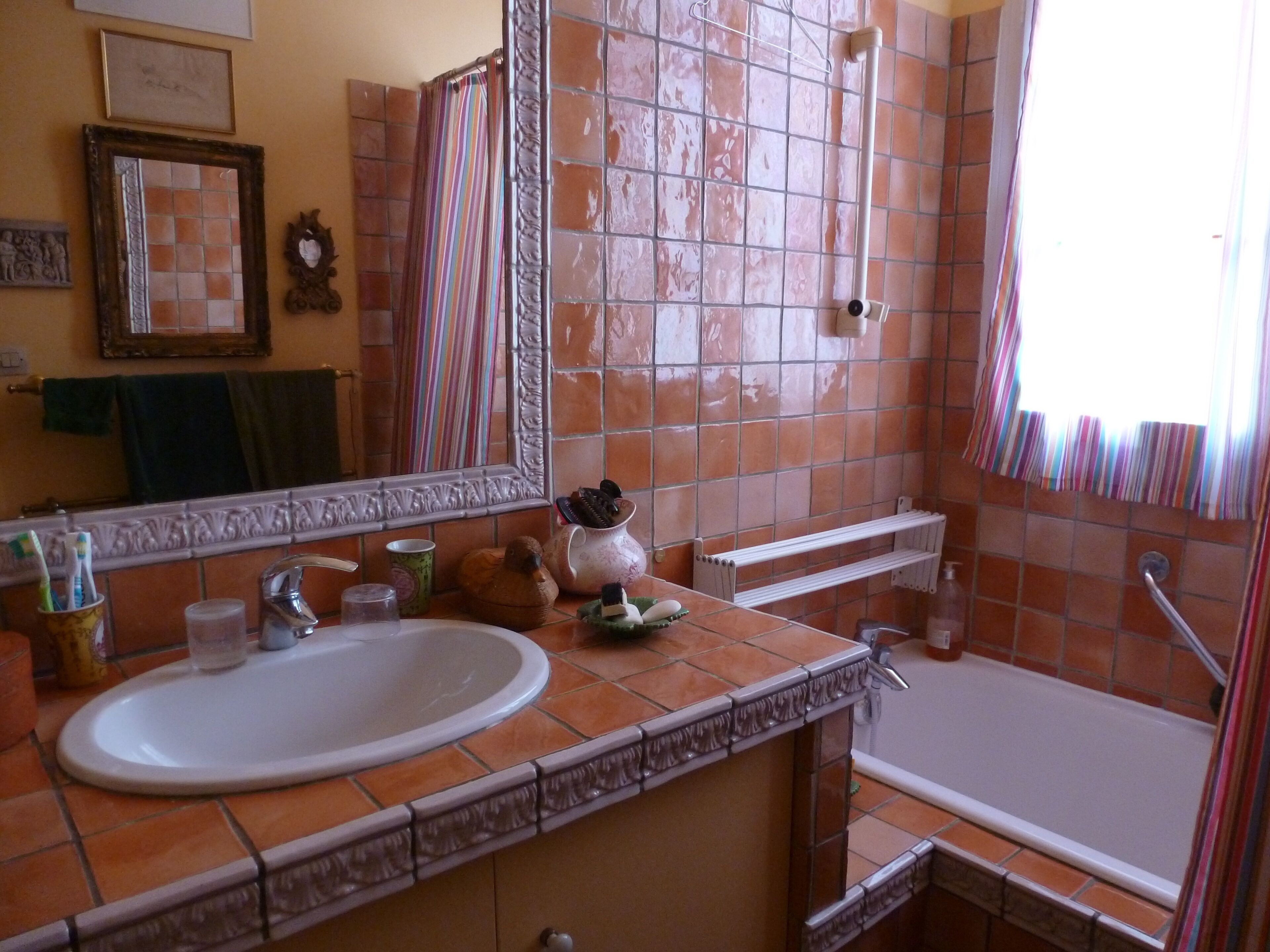 A bathroom with a large sink, a mirror, a shower, and a bathtub.