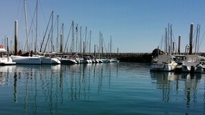 A marina with multiple sailboats docked, calm water, and a clear sky. - Modern villa in Les Sables d'Or with heated pool (Plurien)