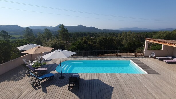 A swimming pool with wooden deck, lounge chairs, and umbrellas. - Very nice villa with heated pool (private pool in August and September)  (Lecci)