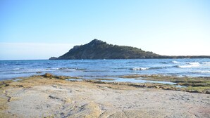 A rocky beach with a prominent rock formation in the distance. - Superb sea-view villa with landscaped pool. Large garden, for 1 or 2 families (Cavalaire-Sur-Mer)