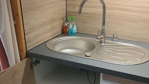 A compact kitchen with a sink, dishwasher, and storage space. - Studio Arc 2000, 4/5 persons, residence Bel Aval, Charlotte Perriand style. (Bourg-Saint-Maurice)