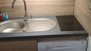A kitchen with a sink, a microwave, a coffee maker, and a dishwasher. - Studio Arc 2000, 4/5 persons, residence Bel Aval, Charlotte Perriand style. (Bourg-Saint-Maurice)