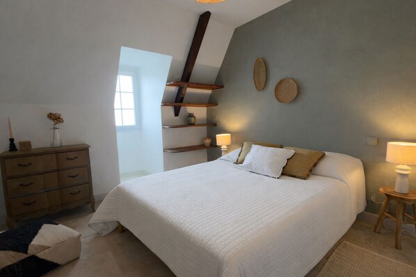 A bedroom with a large bed, wooden dresser, and shelves. - Rental Residence with 2 swimming pools, jacuzzi, sauna, billiards (NABIRAT)