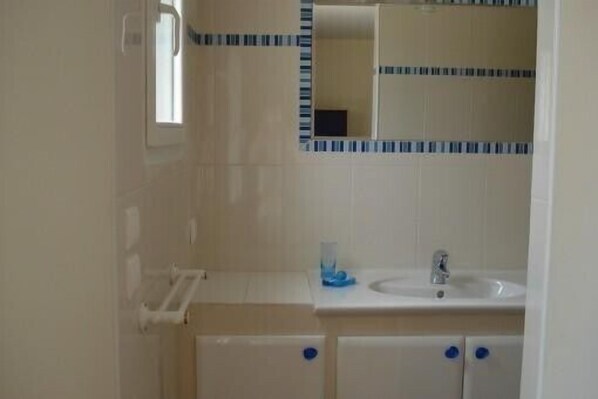 A bathroom with a white sink, mirror, and cabinets. - Bright villa, air conditioned, on 9000m², pool, tranquility and rest assured (Laroque-Des-Albères)
