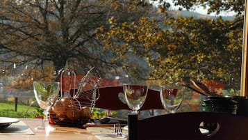Dine al fresco with a view of the surrounding landscape, surrounded by fine glassware and a selection of fresh dishes.