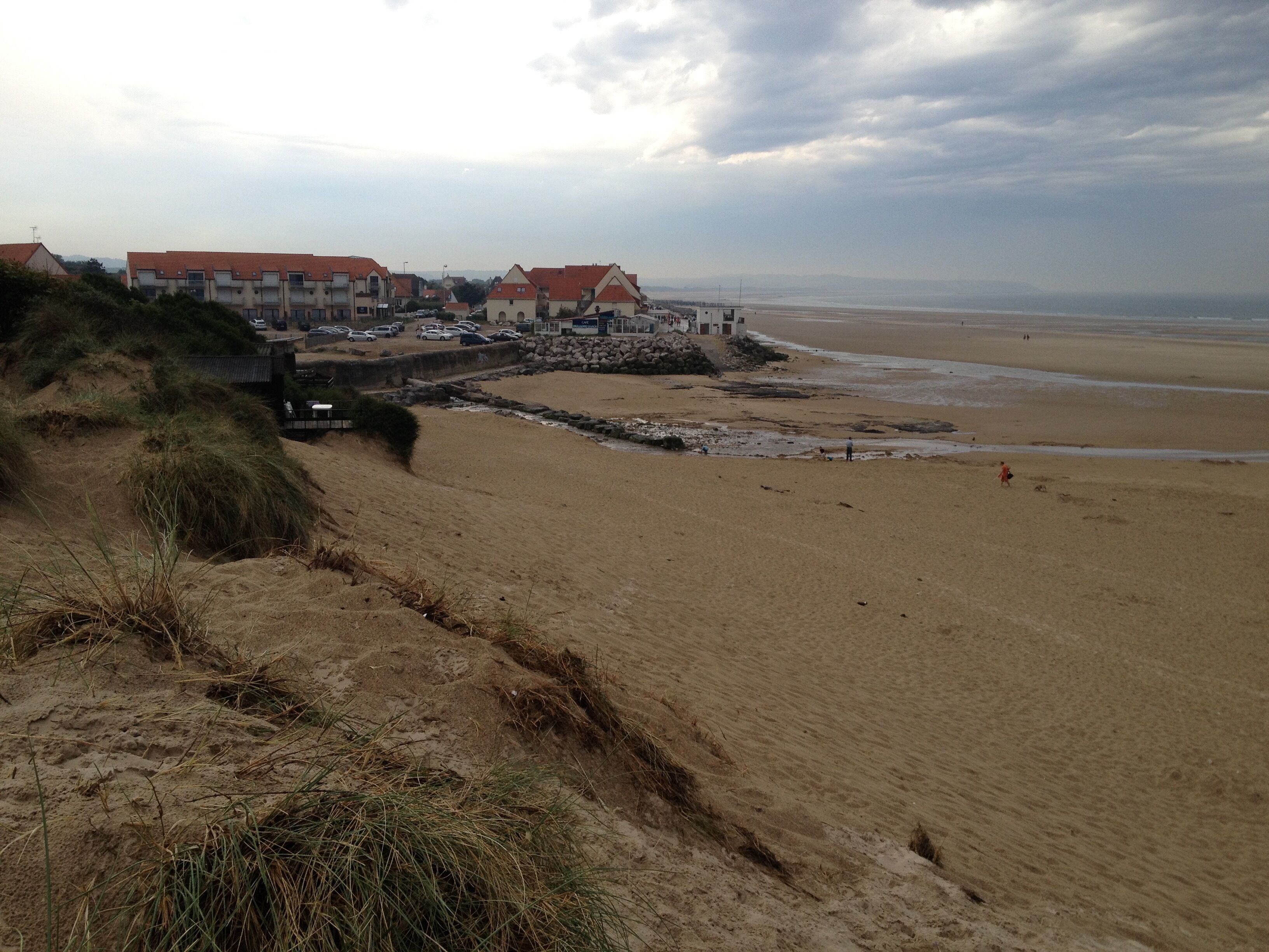 A beach with buildings in the background.
