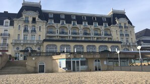A large, historic hotel with multiple balconies and a grand entrance.
