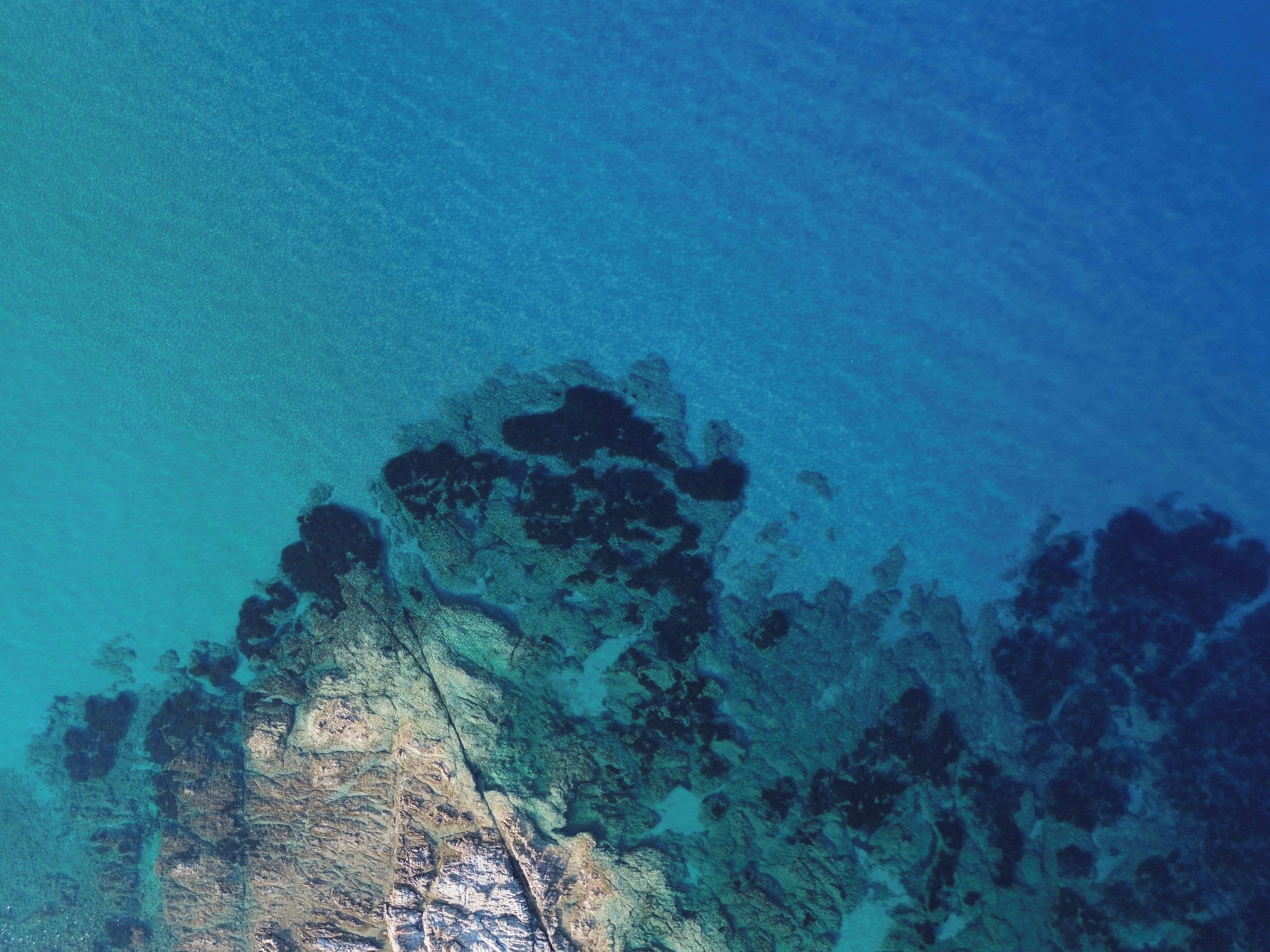 A satellite view of a coastal area with visible land formations and water.
