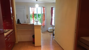 A kitchen with a tiled floor, a sink, and a countertop. There is a door leading to another room. - House La Ciotat, near beach and town center (La Ciotat)